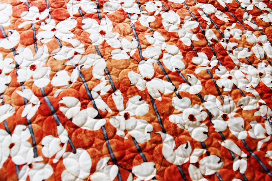 back of quilt with circle finishing stitching and white poppies with orange background back of quilt with circle finishing stitching and white poppies with orange background